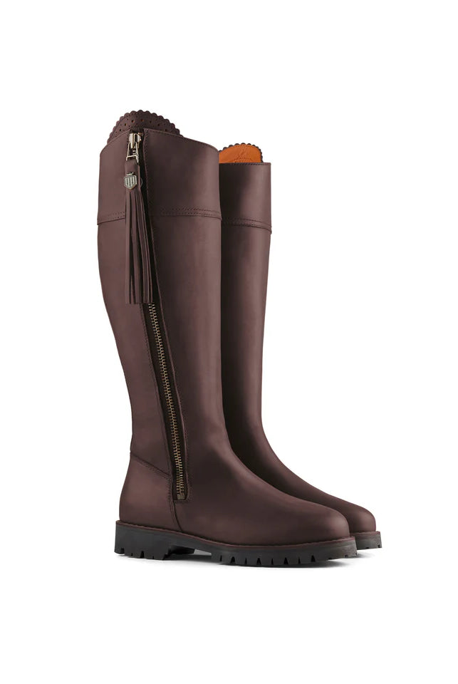 Pair of brown knee-high boots with a zipper on a white background