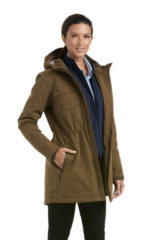 Woman modeling Ariat Argentium Parka in olive green with hood, layered over navy jacket and light blue shirt