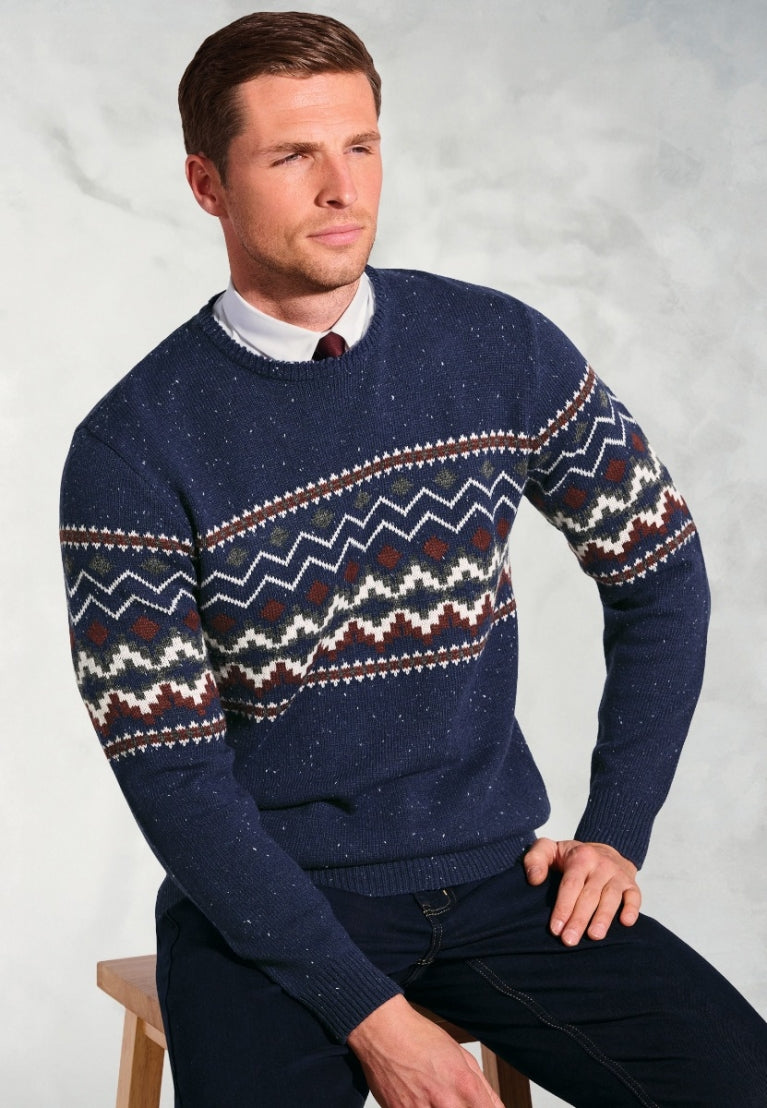 Man wearing navy blue Ainslie Fairisle crew neck sweater with traditional zigzag pattern over white shirt and burgundy tie