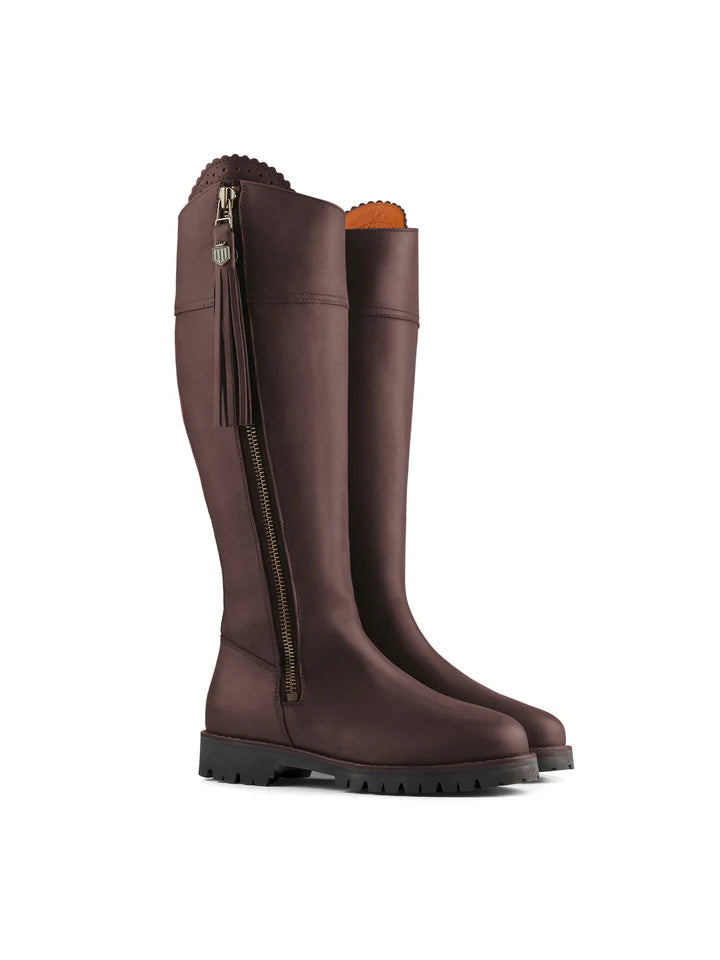 Pair of brown knee-high boots with a zipper on a white background