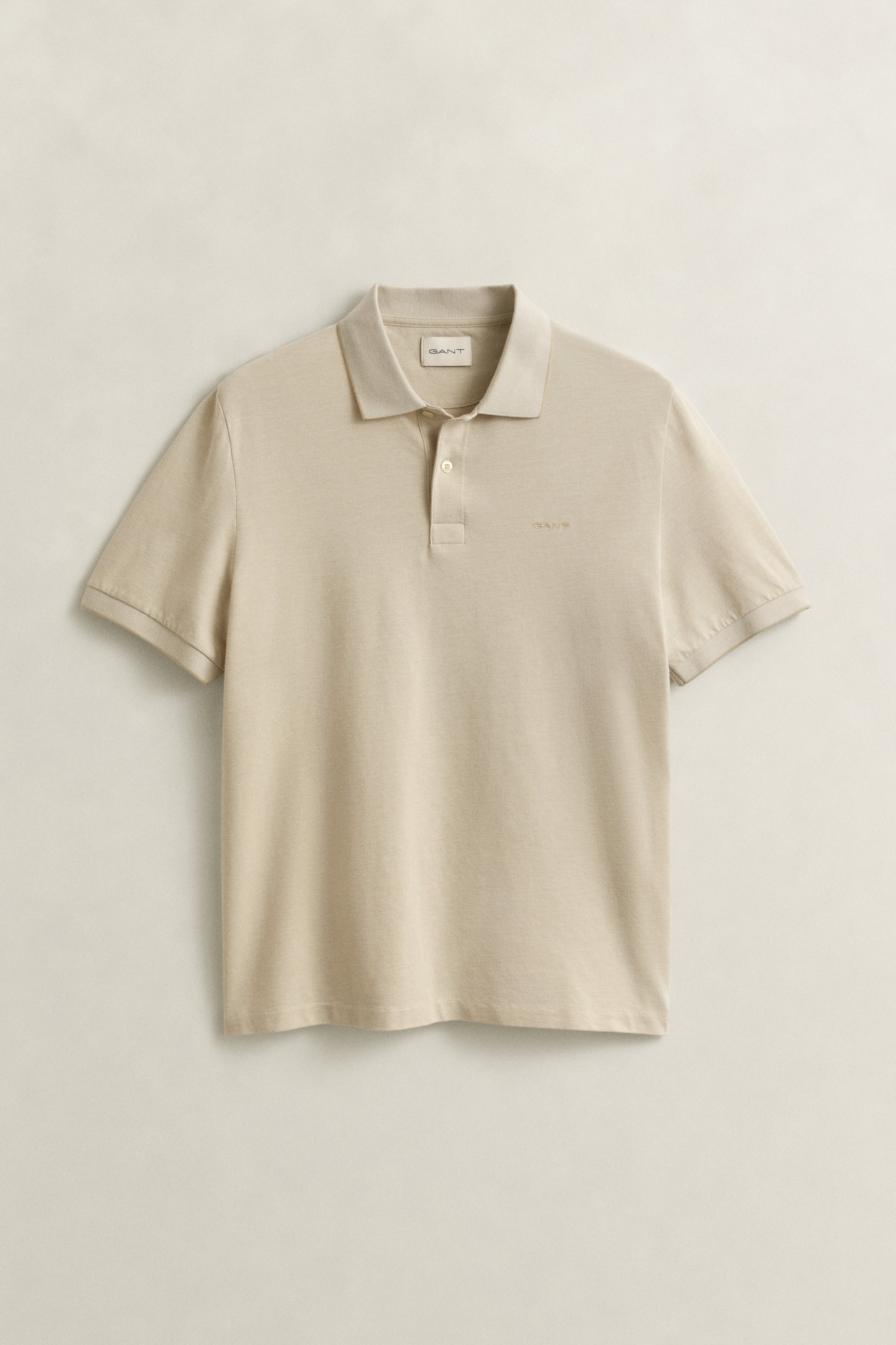 GANT 2 Tone SS Polo shirt in beige with collar, two-button placket, and embroidered logo on chest, laid flat on neutral background