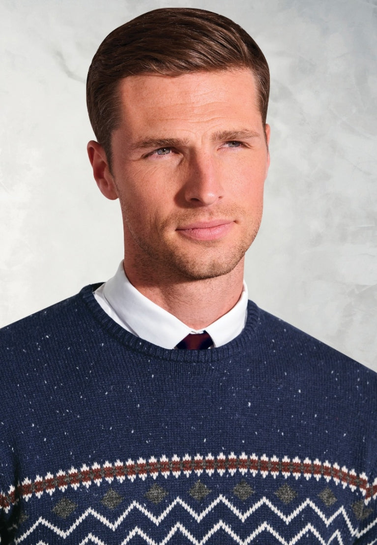 Man wearing navy blue Ainslie Fairisle crew neck sweater with traditional pattern detail over white shirt and burgundy tie